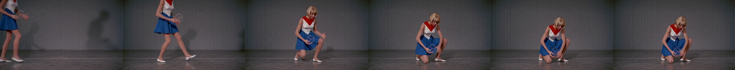 Six frames from arm B. A blonde woman in a red, white and blue dress walks in from the left, then crouches and reaches toward the floor.